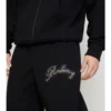 Pantalones de jogging de algodón con logotipo cursivo de cuadros Pantalones de jogging de algodón con logotipo cursivo de cuadros
